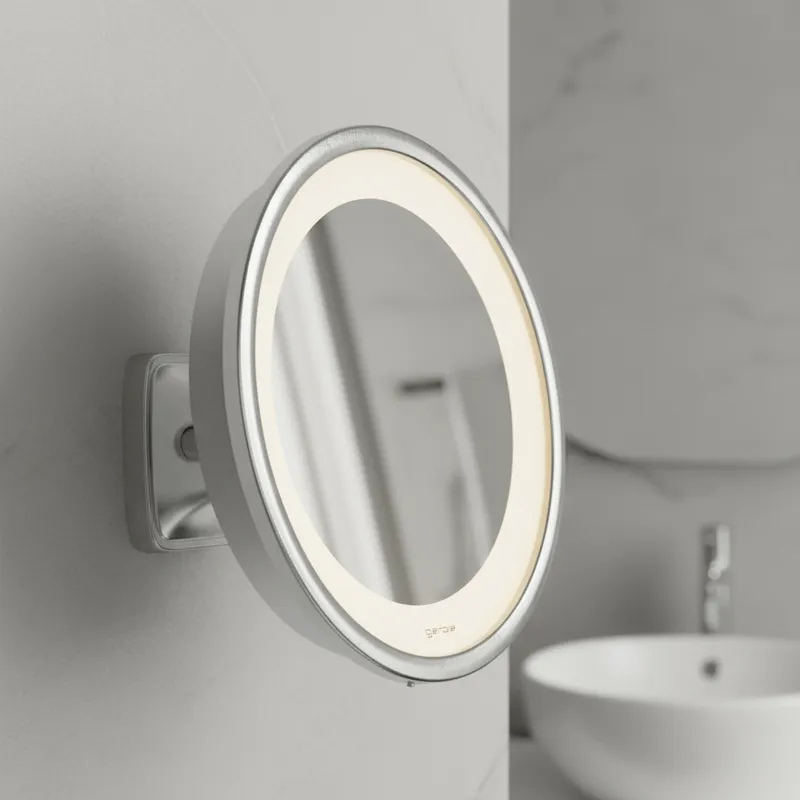 Espelho de aumento para maquiagem com LED, redondo, de parede cromado, detalhe lateral em banheiro.