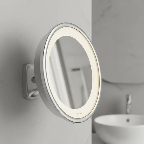 Espelho de aumento para maquiagem com LED, redondo, de parede cromado, detalhe lateral em banheiro.