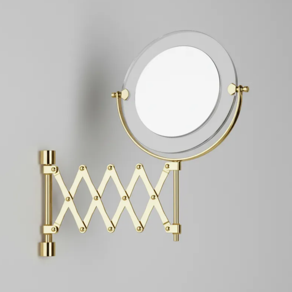 Espelho de aumento para maquiagem com LED, redondo, de parede com braço pantográfico Gold estendido em fundo neutro.